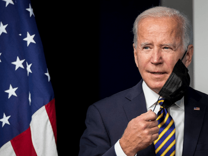 U.S. President Joe Biden removes his face mask as he arrives to speak in the South Court Auditorium on the White House campus October 14, 2021 in Washington, DC. Biden spoke about the coronavirus pandemic and encouraged states and businesses to support vaccine mandates to avoid a surge in cases …