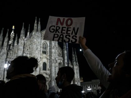 People protest against the so-called Green Pass on Piazza Duomo in Milan on October 16, 2021 as all workers must show since October 15 a so-called Green Pass, offering proof of vaccination, recent recovery from Covid-19 or a negative test, or face being declared absent without pay. (Photo by Piero …