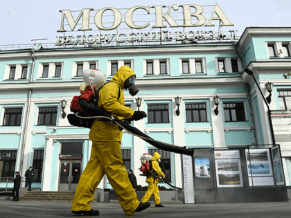 Servicemen of Russia's Emergencies Ministry wearing protective gear disinfect Moscow's Belorussky railway station on October 20, 2021, amid the ongoing coronavirus disease pandemic. - Russia said Wednesday 1,028 people died of Covid over the past 24 hours, a new record, as President Vladimir Putin mulls introducing nationwide restrictions to curb …