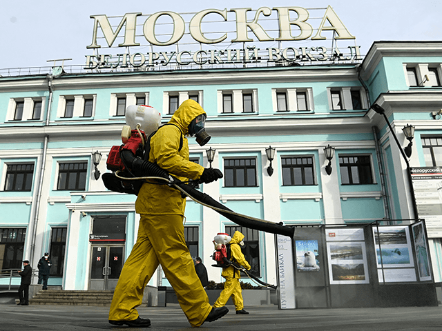 Servicemen of Russia's Emergencies Ministry wearing protective gear disinfect Moscow&