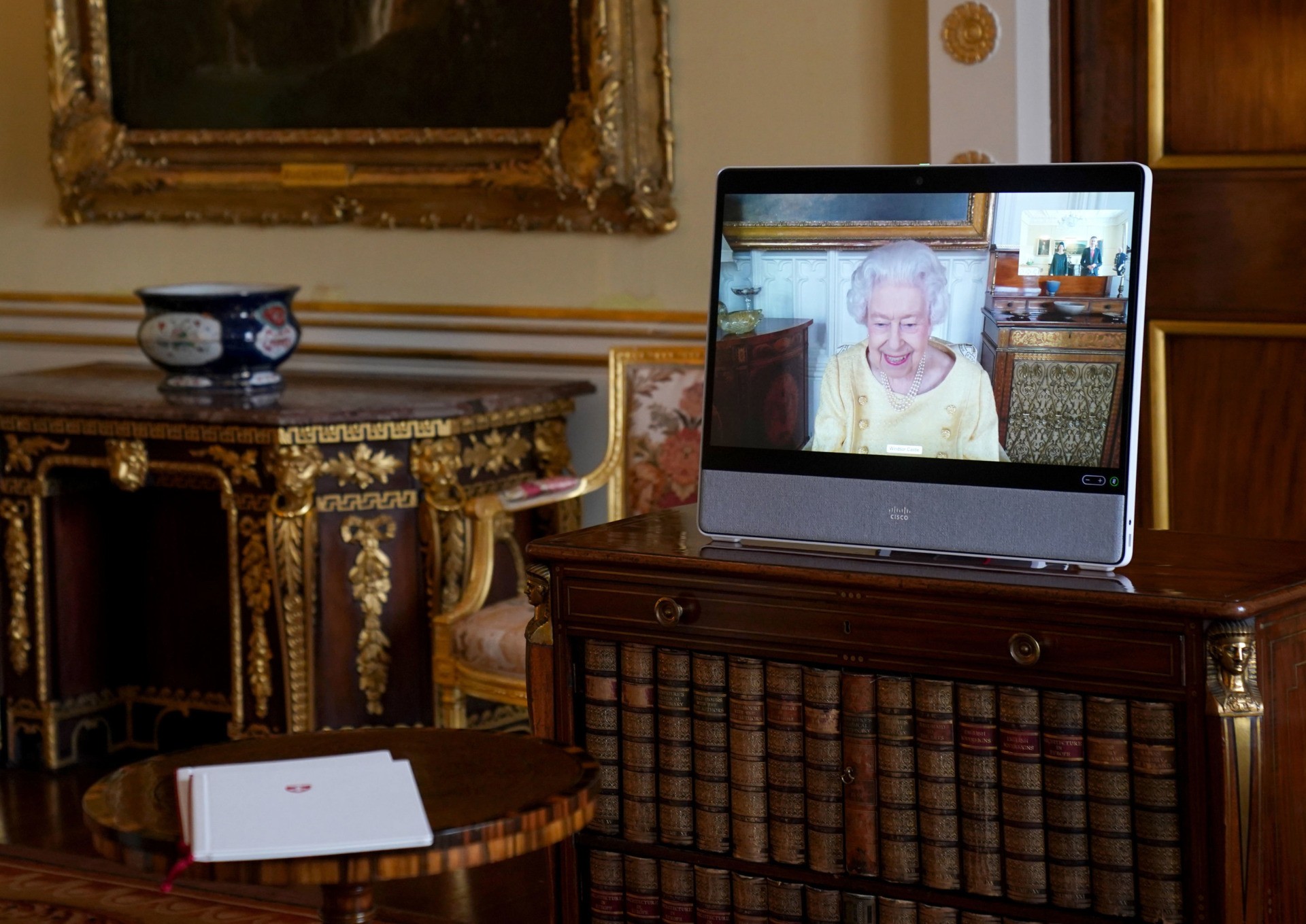 LONDON, ENGLAND - OCTOBER 26: Queen Elizabeth II appears on a screen via videolink from Windsor Castle, where she is in residence, during a virtual audience at Buckingham Palace, on October 26, 2021 in London, England. (Photo Victoria Jones - Pool/Getty Images)