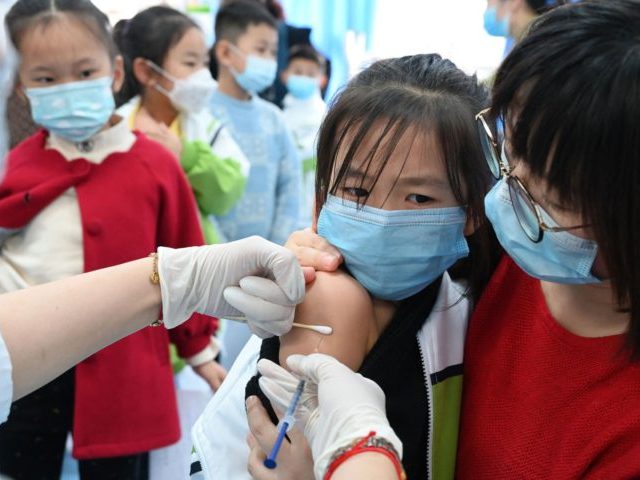 A child receives the Covid-19 coronavirus vaccine at a school in Handan, in China's northe