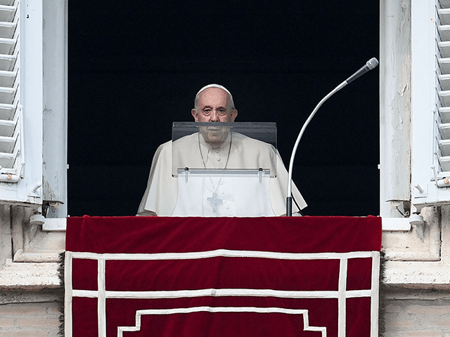 Pope Francis arrives at the window of the apostolic palace to deliver the weekly Angelus p