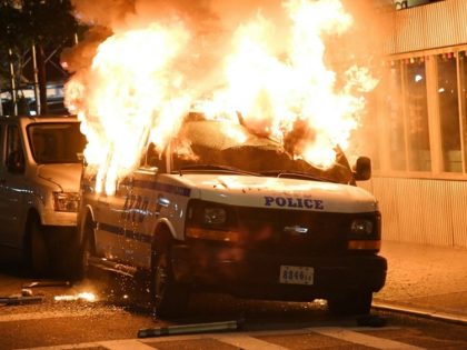 A New York City Police Department vehicle is firebombed with a Molotov cocktail during a George Floyd protest in Brooklyn in May 2020. (Photo: Kevin Mazur/Getty Images)