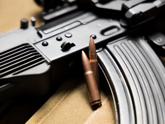 Closeup of a Kalashnikov MKK-104 assault rifle with bullets. 7.62x39 mm. Modern AK-47.
