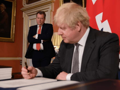 LONDON, ENGLAND - DECEMBER 30: UK chief negotiator David Frost (L) looks on as Prime Minister, Boris Johnson (R) poses for photographs after signing the Brexit trade deal with the EU in number 10 Downing Street on December 30, 2020 in London, United Kingdom. The United Kingdom and the European …