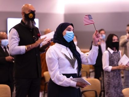 CAMP SPRINGS, MARYLAND - MAY 27: New U.S. citizens celebrates after taking their Oath of Allegiance during a Naturalization Ceremony at the United States Citizenship and Immigration Services (USCIS) Headquarters on May 27, 2021 in Camp Springs, Maryland. This special Naturalization Ceremony honored Asian American Pacific Islanders and was the …