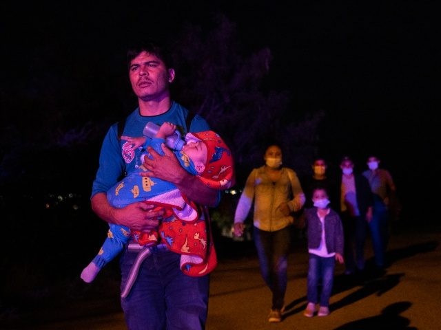 ROMA, TEXAS - JUNE 17: Immigrants seeking asylum walk to be processed and taken to a borde
