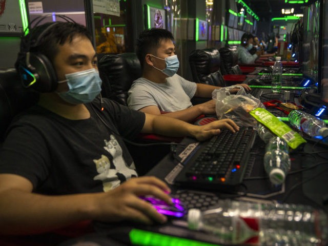 BEIJING, CHINA - SEPTEMBER 11: People play online video games in a game arcade on Septembe