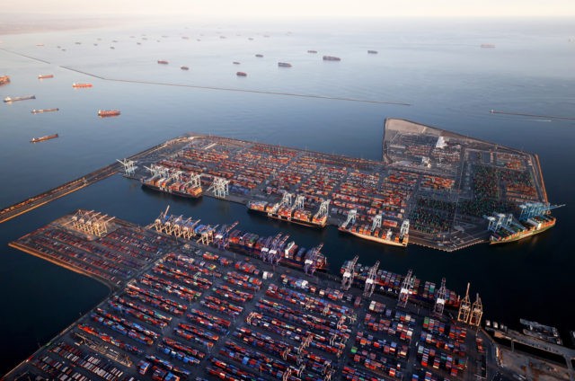 In an aerial view, container ships (Top L) are anchored by the ports of Long Beach and Los Angeles as they wait to offload on September 20, 2021 near Los Angeles, California. Amid a record-high demand for imported goods and a shortage of shipping containers and truckers, the twin ports …