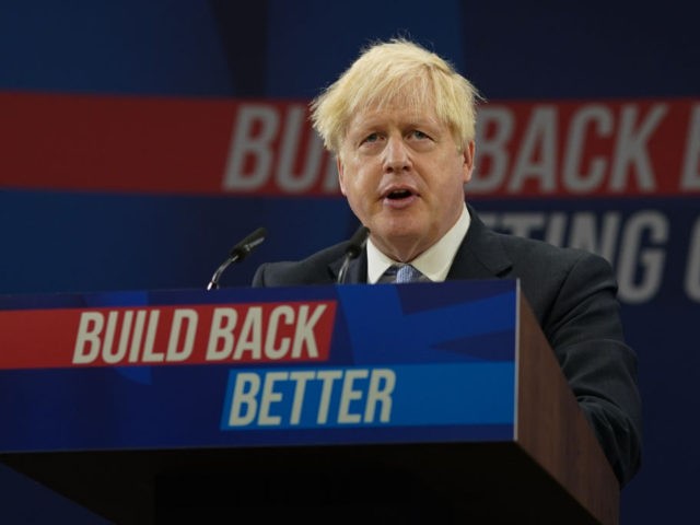 MANCHESTER, ENGLAND - OCTOBER 06: Britain's Prime Minister Boris Johnson delivers his leader's keynote speech during the Conservative Party conference at Manchester Central Convention Complex on October 6, 2021 in Manchester, England. This year's Conservative Party Conference returns as a hybrid of in-person and online events after last year it …