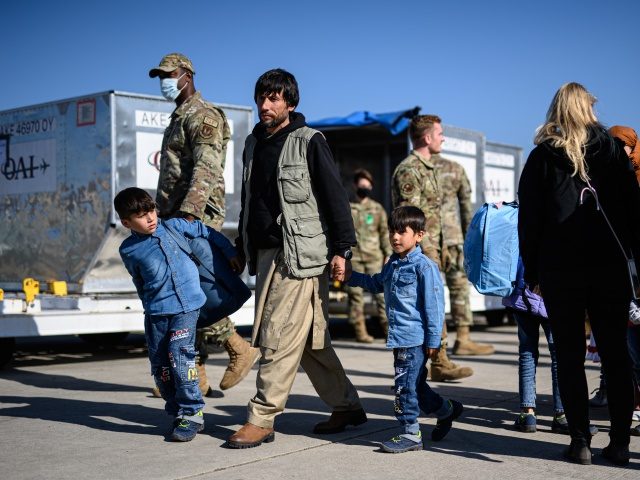 RAMSTEIN-MIESENBACH, GERMANY - OCTOBER 09: Evacuees from Afghanistan drop off their luggage to board a passenger plane bound for the U.S. at the U.S. military's Ramstein air base on October 09, 2021 in Ramstein, Germany. At least 11,000 Afghan evacuees flown of out of Kabul by the U.S. military following …