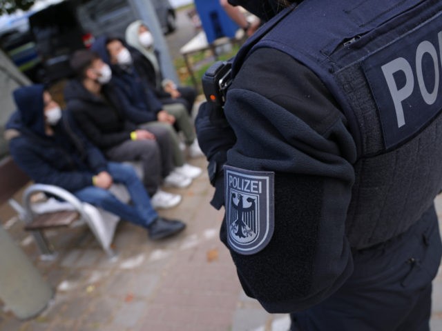 FRANKFURT (ODER), GERMANY - OCTOBER 12: A German federal police officer stands over four m
