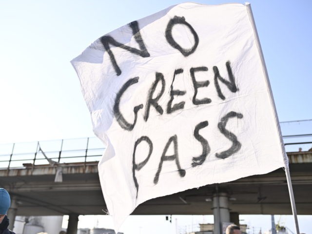 GENOA, ITALY - OCTOBER 15: Protester holds a no green pass flag in front of Genoa Port on