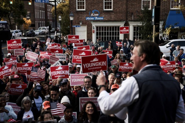 ALEXANDRIA, VIRGINIA - OCTOBER 30: Supporters listen as Virginia Republican gubernatorial candidate Glenn Youngkin delivers remarks to supporters at the Old Town Alexandria Farmers Market on October 30, 2021 in Alexandria, Virginia. Youngkin is on the last few days of his campaign bus tour across the state of Virginia as …