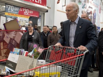 US Vice President Joe Biden pushes a full shopping cart during a visit to a Costco store i
