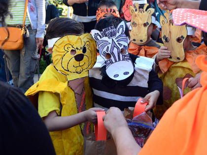 Children dressed as zoo animals from Happy Day School in Monterey Park, California, celebrate Halloween on October 31, 2013 by going trick or treating at a nearby home which has provided services to the developmentally disabled community since the mid 1950's. AFP PHOTO/Frederic J. BROWN (Photo credit should read FREDERIC …