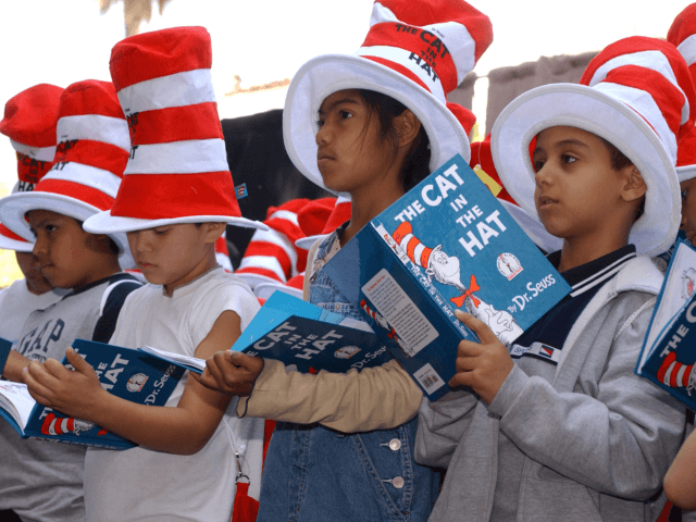 HOLLYWOOD - MARCH 11: Children read from "The Cat in the Hat" book at a ceremony honoring the late children's book author Dr. Seuss (Theodore Geisel) with a star on the Hollywood Walk of Fame on March 11, 2004 in Hollywood , California. (Photo by Vince Bucci/Getty Images)