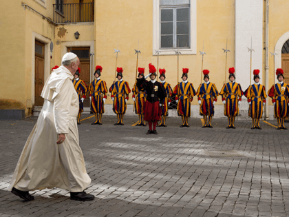 Pope Francis leaves past Swiss guards at the end of a private audience with Senegal's Pres