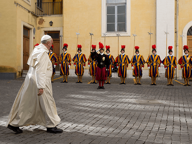 Pope Francis leaves past Swiss guards at the end of a private audience with Senegal's Pres