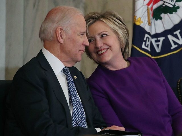 WASHINGTON, DC - DECEMBER 08: Former US Secretary of State, Hillary Clinton shares a laugh with US Vice President Joseph Biden, during a portrait unveiling ceremony for outgoing Senate Minority Leader Harry Reid (D-NV), on Capitol Hill December 8, 2016 in Washington, DC. (Photo by Mark Wilson/Getty Images)