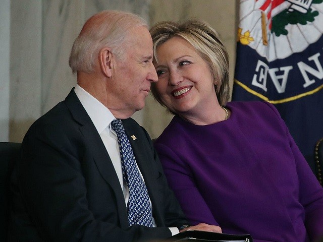 WASHINGTON, DC - DECEMBER 08: Former US Secretary of State Hillary Clinton shares a laugh with US Vice President Joseph Biden, during a portrait unveiling ceremony of outgoing Senate Minority Leader Harry Reid (D- NV), on Capitol Hill on December 8, 2016. in Washington, DC.  (Photo by Mark Wilson/Getty Images)
