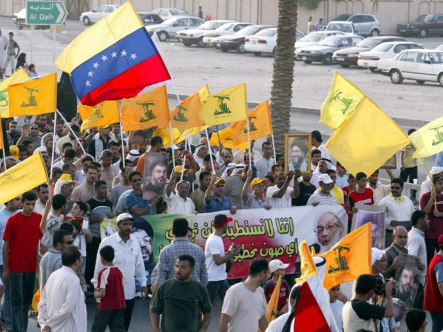 Manama, BAHRAIN: Bahrainis wave a Venezuelan flag among Lebanese militia Hezbollah flags a