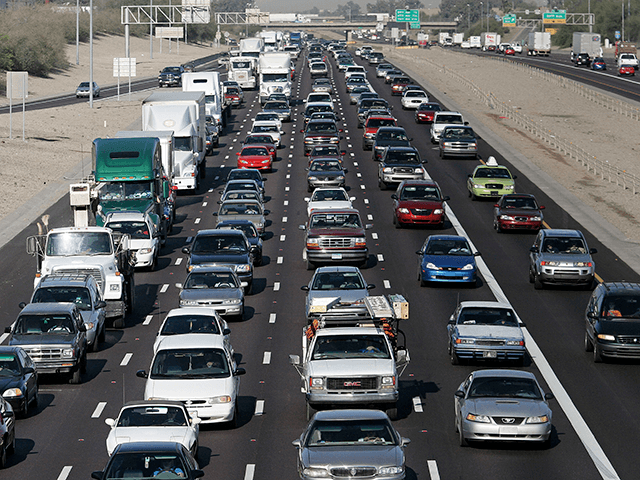 Phoenix commuters drive on the I-10 Freeway during the morning commute to work April 5, 2005 in Phoenix, Arizona. A study recently released by the U.S. Census Bureau says the average American commuter spends 200 hours a year driving to and from work. In the Phoenix metropolitan area commuters average more than 224 hours per year or 9.5 days driving to and from work. On average 76 percent of all commuters drive alone. (Photo by Jeff Topping/Getty Images)