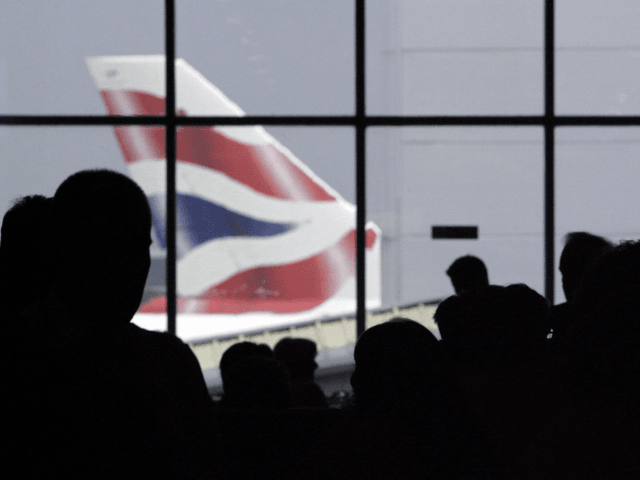HEATHROW, UNITED KINGDOM: (FILES) A British Airways aircraft is pictured as passengers queue at London's Heathrow airport, in south-east England, 14 August 2006. British Airways announced Thursday 25 January 2007, the cancellation of all its flights from London's Heathrow airport for two days next week during a planned strike. Speaking …