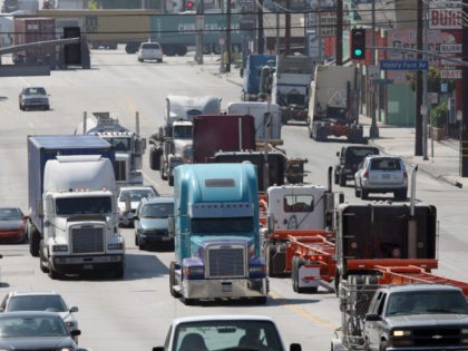 LONG BEACH, CA - SEPTEMBER 08: Trucks are driven near the Ports of Long Beach and Los Angeles, the busiest port complex in the US, on September near Lon Beach, California. The federal judge tentatively denied the largest trucking association, the American Trucking Association, from blocking the new anti-pollution measures …