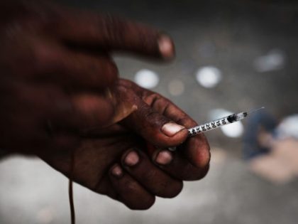 NEW YORK, NY - OCTOBER 06: A heroin user displays a needle in a South Bronx neighborhood which has the highest rate of heroin-involved overdose deaths in the city on October 6, 2017 in New York City. Like Staten Island, parts of the Bronx are experiencing an epidemic in drug …