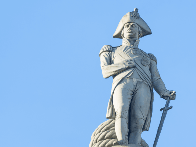 The famous statue of Admiral Nelson on Trafalgar Square in London, UK, on blue clear sky