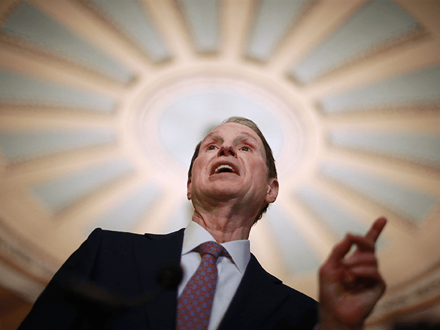 U.S. Sen. Ron Wyden (D-OR) talks with reporters following the weekly Democratic policy luncheon at the U.S. Capitol April 17, 2018 in Washington, DC. Noting that Tuesday was Tax Day, the Democrats said the recent tax reform legislation penned by Republicans was mostly benefitting corporations and their shareholders. (Photo by …