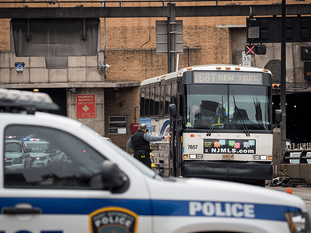Law enforcement officials gather near the scene of a New Jersey Transit bus that was involved in a morning crash near the Manhattan entrance to the Lincoln Tunnel, May 18, 2018 in New York City. According to officials from the New York City Fire Department (FDNY), a New Jersey Transit …