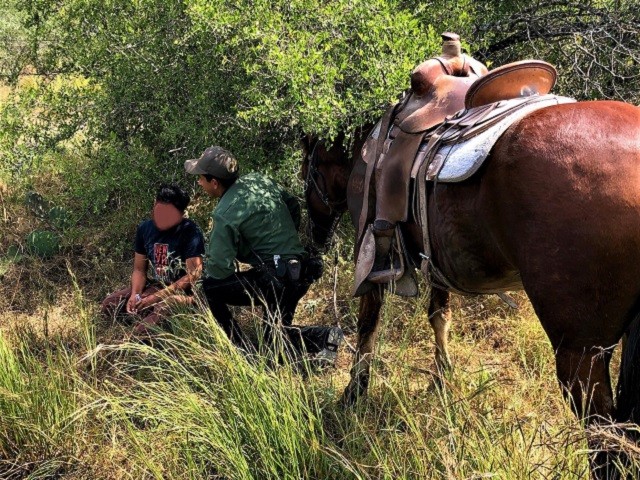 A horseback-mounted Border Patrol agent rescues a distressed migrant on a ranch near Hebbronville, Texas. (Photo: U.S. Border Patrol/Laredo Sector)
