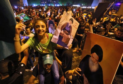 Supporters of Iraqi Shiite cleric Moqtada al-Sadr celebrate in Baghdad's Tahrir square on October 11, 2021 following the announcement of parliamentary elections' results. (Ahmad Al-Rubaye/AFP via Getty Images)