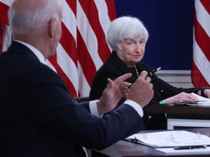 Treasury Secretary Janet Yellen (C) listens to President Joe Biden during a hybrid meeting