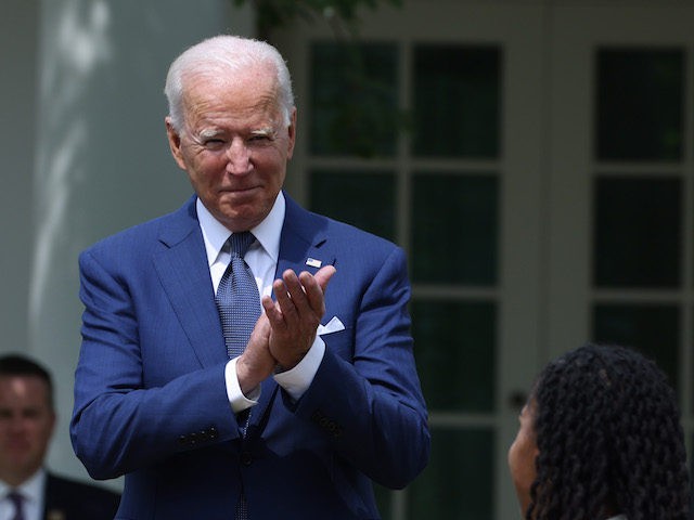 Harris and U.S. President Joe Biden applaud during an event in the Rose Garden of the Whit