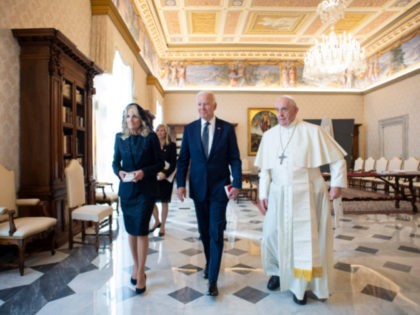 US President Joe Biden, first lady Jill Biden and Pope Francis walk as they meet at the Va
