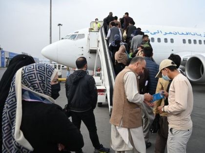 Passengers prepare to board on a domestic flight at the airport in Kabul on October 26, 20