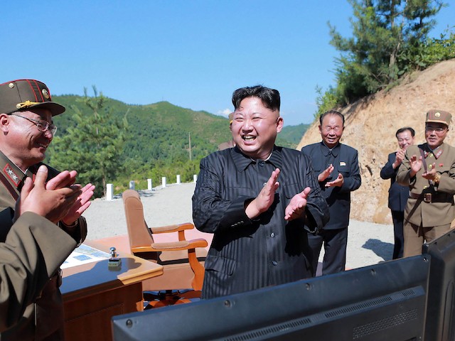 This picture taken on July 4, 2017 and released by North Korea's official Korean Central News Agency (KCNA) on July 5, 2017 shows North Korean leader Kim Jong-Un (C) celebrating the successful test-fire of the intercontinental ballistic missile Hwasong-14 at an undisclosed location. (STR/AFP via Getty Images)