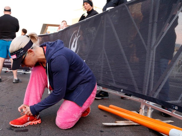 TEMPE, ARIZONA - JANUARY 20: Senator Kyrsten Sinema (D-AZ) laces up her shoes before running in the Humana Rock 'n' Roll 1/2 Marathon on January 20, 2019 in Tempe, Arizona. (Photo by Chris Coduto/Getty Images for Rock 'n' Roll Marathon)
