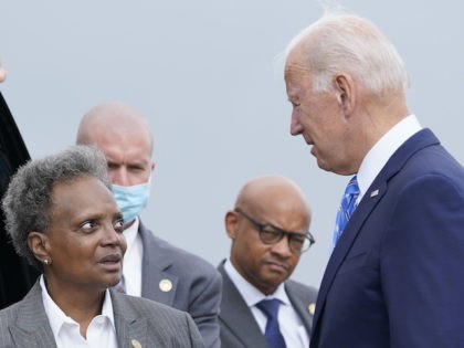President Joe Biden greets Chicago Mayor Lori Lightfoot at O'Hare International Airport in Chicago, Thursday, Oct. 7, 2021. While in the Chicago area, Biden will highlight his order to require large employers to mandate COVID-19 vaccines for its workers during a visit to a construction site. (AP Photo/Susan Walsh)