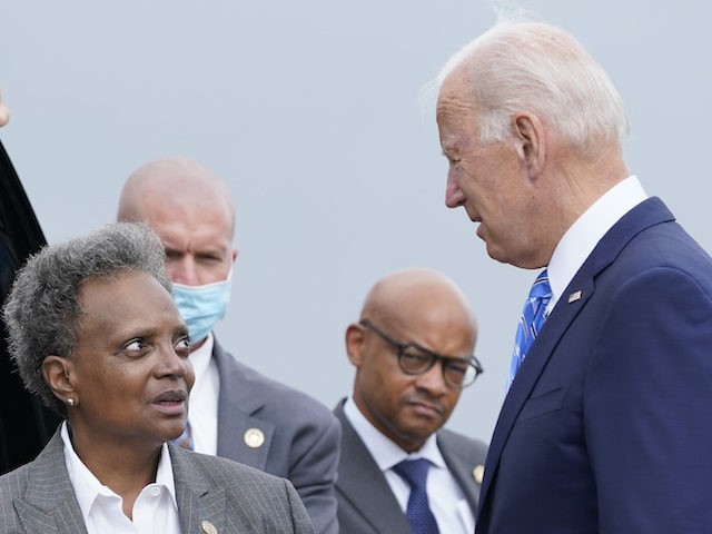 President Joe Biden greets Chicago Mayor Lori Lightfoot at O'Hare International Airport in