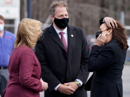 Vice President Kamala Harris is greeted by Sen. Maggie Hassan, D-N.H., left, New Hampshire Gov. Chris Sununu, center, Friday, April 23, 2021, at Laconia Municipal Airport in Gilford, N.H., on arrival to New Hampshire. (AP Photo/Jacquelyn Martin)