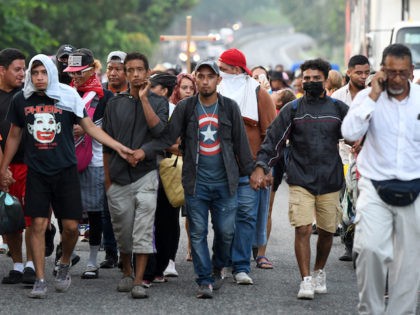 Migrants heading to Mexico City to request asylum and refugee status walk in caravan in Hu