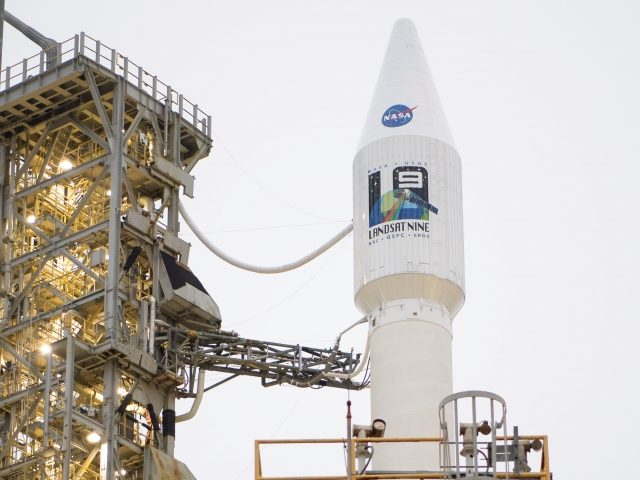 VANDENBERG SPACE FORCE BASE, CA - SEPTEMBER 27: In this handout photo provided by NASA, the United Launch Alliance (ULA) Atlas V rocket with the Landsat 9 satellite onboard is seen after the mobile launcher platform (MLP) was rolled back on September 27, 2021 at Vandenberg Space Force Base in …