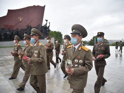 North Korean military officials prepare to bow as they arrive to pay their respects before the statues of late North Korean leaders Kim Il Sung and Kim Jong Il at Mansu Hill, as the country marks the 76th founding anniversary of the Workers' Party of Korea, in Pyongyang on October …