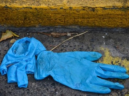 A pair of gloves lie on the floor, after been used to prevent the spread of the new coronavirus, COVID-19, in Tegucigalpa, on March 26, 2020. (ORLANDO SIERRA/AFP via Getty Images)