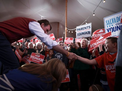 WARRENTON, VIRGINIA - OCTOBER 29: Virginia Republican gubernatorial candidate Glenn Youngkin shakes hands with a supporter as he walks onstage for a campaign rally at the the Inn at Vint Hill on October 29, 2021 in Warrenton, Virginia. Youngkin is on a campaign bus tour across the state of Virginia …